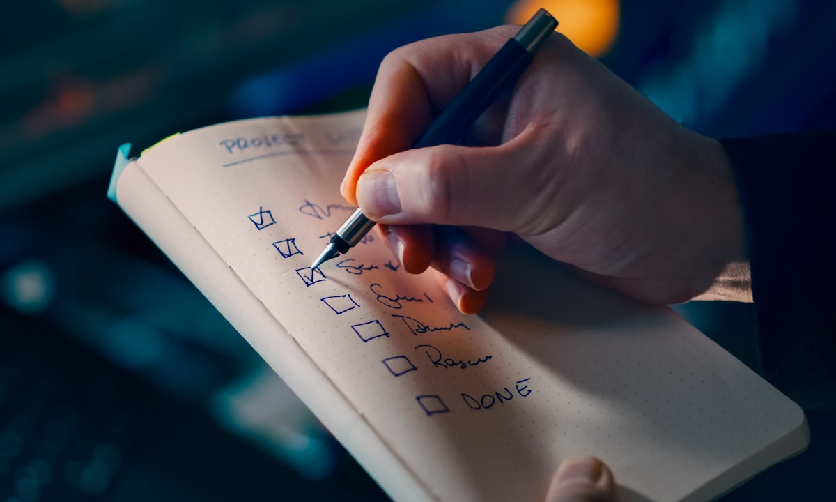 A hand working through a to-do list. Most companies can close the first six points in a week.