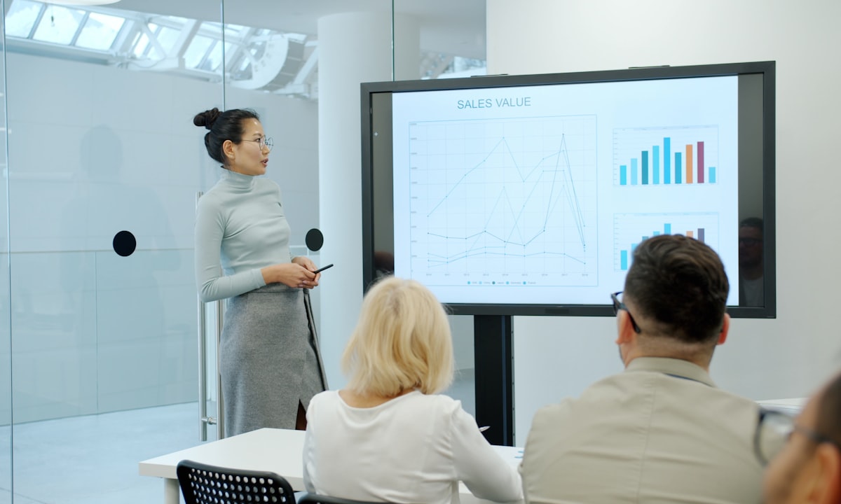 Someone presenting a chart. Every number on the slide must be one you can defend when asked.